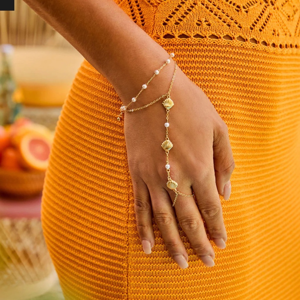 Golden sea shell hand charm